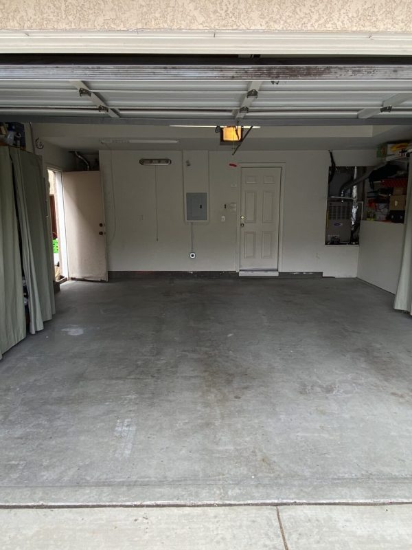 empty two-car garage with shelves on the right