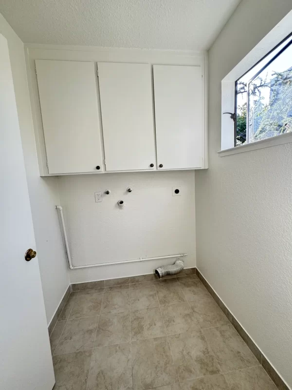 Laundry room and cabinets before being upgraded